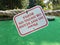 Please do not stand or swing on rope sign upside down on miniature golf course