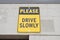 Please Drive Slowly Yellow And Black Sign