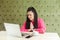 Please help me! Portrait of young beautiful student with black dreadlocks hairstyle in pink blouse sitting in cafe and talking