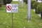 Please keep off the grass sign on green lawn grass blurred bokeh background on sunny summer day. City lifestyle and nature