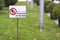 Please keep off the grass sign on green lawn grass blurred bokeh background on sunny summer day. City lifestyle and nature