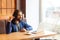 Please little bit! Portrait of cunning young adult man freelancer in casual style sitting in cafe with laptop, looking at camera,