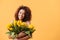 Pleased african woman hugging bouquet of flowers