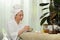 Pleased caucasian woman preparing yogurt and turmeric for facial mask. Beauty treatment and self care concept