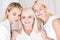 Pleased elegant three-generation blonde women
