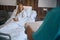 Pleased female patient being served meal in medical facility ward