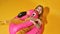 Pleased girl hug inflatable flamingo rubber ring