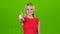 Pleased girl shows gesture all right, thumbs up. Green screen