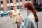 Pleased grey-haired business lady walking towards her friend