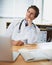 Pleased with his patients progress. a young doctor sitting in his office and smiling thoughtfully.