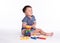 Pleased kid playing toy blocks isolated