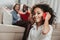 Pleased kid using cellphone in living room