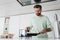 pleased man preparing pancakes for breakfast