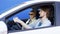 Pleased man and woman have a nice talk in a car. They are both wearing casual clothes. Handsome driver and elegant