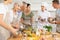 Pleased old woman attendee of cooking course learning how to mix sauce