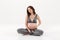 Pleased pregnant woman sitting on the floor while listening music