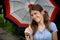 Pleased smiling girl under an umbrella