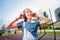 Pleased teenager touching headphones with both hands