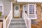 Pleasing home with stairs and half hexagon shaped window at the facade