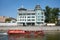 A pleasure boat sails down the river in front of the old administrative building built in 1900, Sadovnicheskaya Embankment