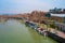 Pleasure boats are moored on the embankment. Summer day