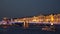 Pleasure boats sail under the palace bridge in St. Petersburg at night