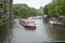 Pleasure excursion traditional boats on the Amstel River in Amsterdam