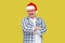 Pleasure happy modern middle aged man in red santa cap, eyeglass