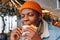 Pleasured African-America guy eats tasty hamburger in cafe