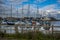 A plethora of pleasure boats with a backdrop of containers at Eling Marina near Southampton, UK