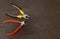 Pliers pair tools base wire repair wires background manufacturing on a dark background copy spase