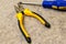 Pliers screwdriver screwdriver with blue handle focus bottom of frame close-up tool manual help to master