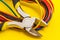 Pliers tool and wires for electrician closeup service repairing concept on yellow background