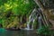 Plitvice Lakes National Park, Croatia - July 25 2018: Couple on a boat enjoying waterfall at Plitvice National Park