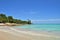 Plot of the beach, coastline of the Caribbean Sea, beautiful azure sea, green tropical vegetation, against the blue sky