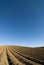 Ploughed field blue sky