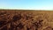 Ploughed field and blue the sky steadicam motion agriculture. Abstract perspective view to dark wide wet soil ways