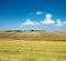 Ploughed and green field