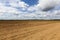 ploughed soil on which cereals are grown