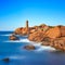 Ploumanach lighthouse sunset in pink granite coast, Brittany, France.