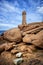 Ploumanach Mean Ruz lighthouse between the rocks in pink granite coast, Perros Guirec, Brittany, France