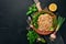 Plov Rice with meat and vegetables on a plate. Uzbek cuisine. On a wooden background. Top view