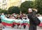 Plovdiv, Bulgaria July - 10.2020: Reporter photographs group of people in protective masks with Bulgarian flags