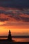 Plover Scar lighthouse with fiery clouds sunset