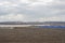 Plowed field against the background of clouds and sunbeams. Spring cleaning of the land, preparation for planting crops