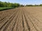 Plowed field with fertile land. Cornfield with wheat. Agricultural work on the ground. Rural landscape. Serbia, the Balkans