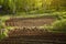 Plowed field prepared for planting. Vegetable garden in the village for potatoes, beets and other home vegetables. Spring is a