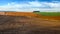 plowed field and soybean brown field in autumn and winter cereals in the distance, patchwork and field lines