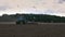 Plowed field by tractor in brown soil on open countryside nature