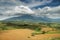 Plowed field and tropical mountain